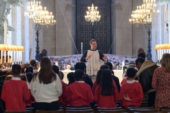 Conductor leading choir of children