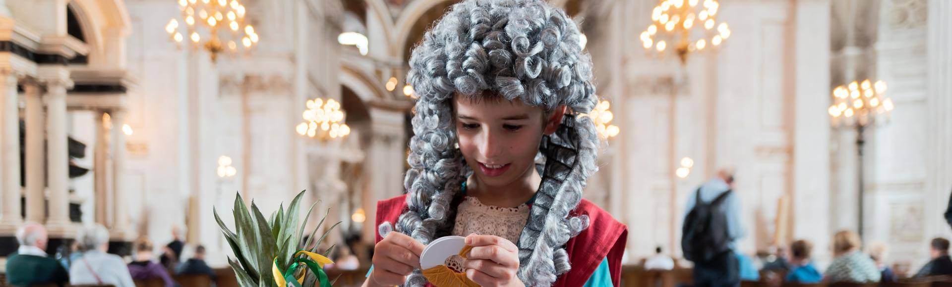 child dressed as Christopher Wren doing craft activities
