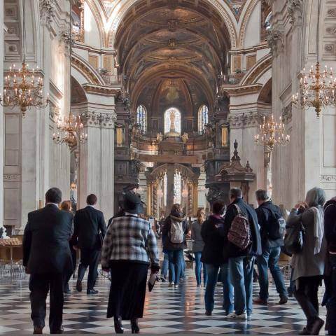 visitors sightseeing walking up nave