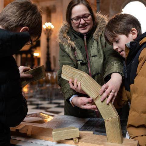 young family working on bridge activity