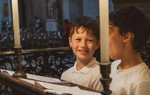 Boy smiling in the choir stalls