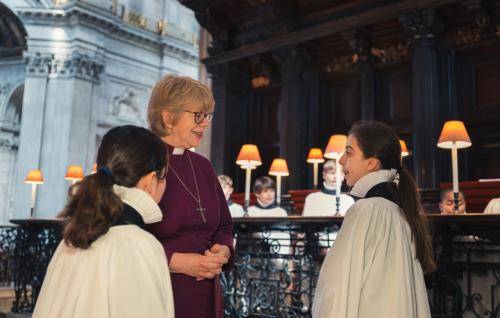 Bishop Sarah, Bishop of London, speaking to two choristers